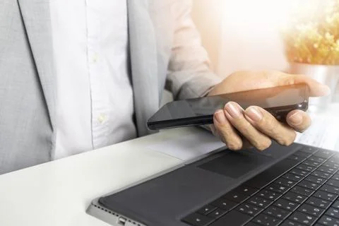 Executives hold their phones to read work messages and schedule work. Stock Photos
