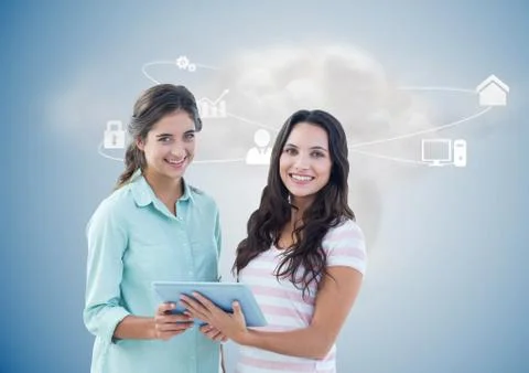 Executives holding digital tablet with networking icons and cloud in background Foto stock