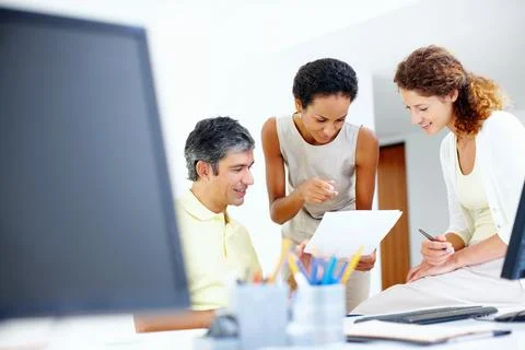 Executives looking at paperwork. Casually dressed executives taking a look at Stock Photos