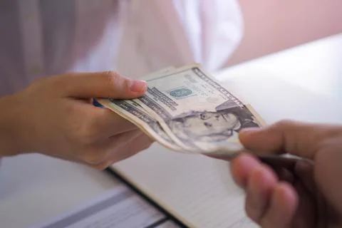 Executives or supervisors pay salaries or bonuses to employees. loan and fina Stock-Fotos