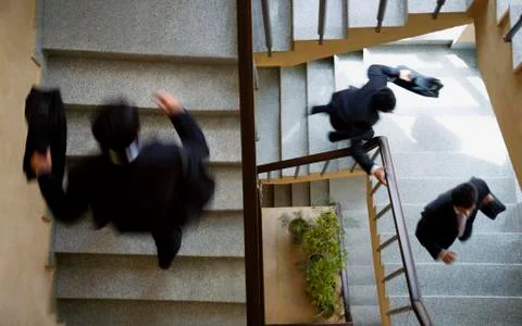 Executives running up the stairs Stock Photos