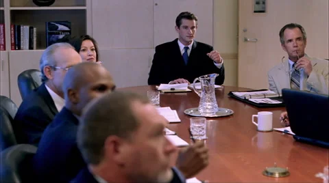 Executives seated around conference table, listening to speaker and taking notes Stock Footage 59240029