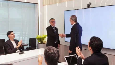 Executives shake hands in corporate boardroom during business meeting Stock Footage 315675215