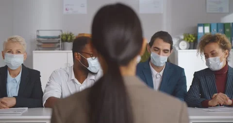 Executives wearing protective mask interviewing woman applicant Stock Footage 154152101