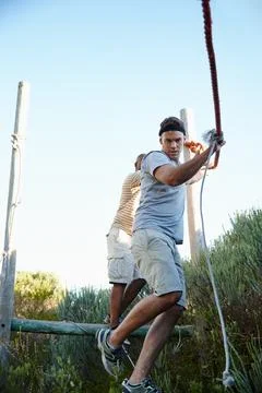 Exercise and adventure. men going through an obstacle course at bootcamp. Fotos de archivo
