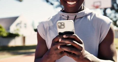Exercise, app and phone with hands of man on basketball court for message Stock Photos