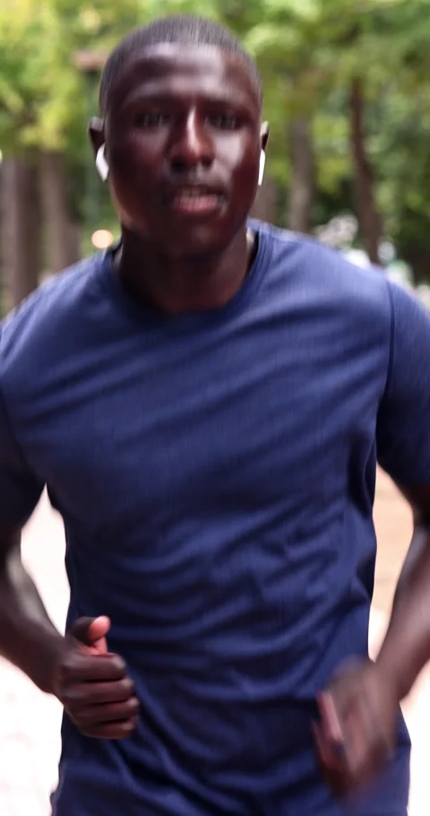 Exercise, black man and running at park with earphones, cardio endurance and Stock Footage 340812863