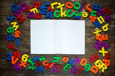 Exercise-book with plastic letters and numbers Open exercise-book with col... Stock Photos