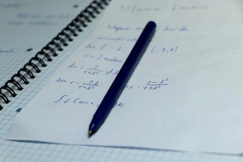 A exercise book for practising math in home. Blue pen with papers are casual  Stock Photos