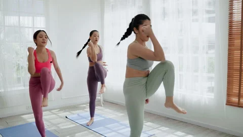 In the exercise class, girls Asians doing cardio exercises Stock Footage 164469103
