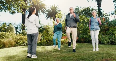 Exercise, class or old people outdoor with personal trainer, movement together Stock Photos