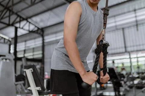 Exercise concept The hefty man with his grey sport top and black pants standi Stock Photos