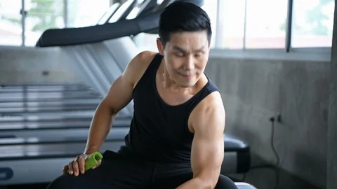 Exercise concept. The young man is lifting the dumbbell in the gym. Stock Footage 112214259