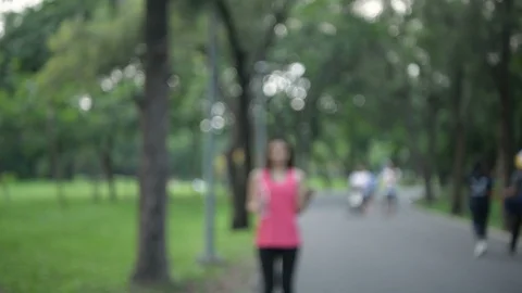 Exercise concepts. Young athletes are drinking and playing mobile in the park Stock Footage 119889312