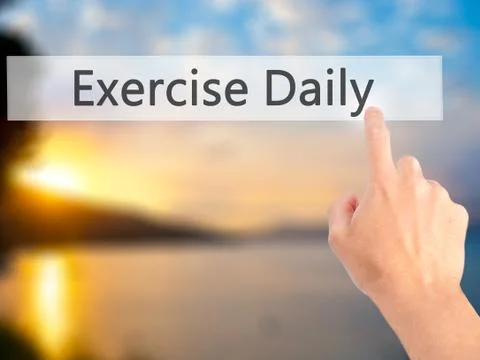 Exercise Daily - Hand pressing a button on blurred background concept on visu 写真素材