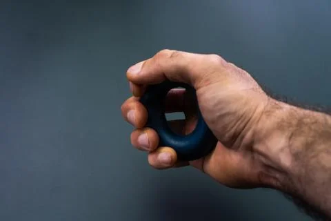 Exercise hand exercises on a black background Stock Photos