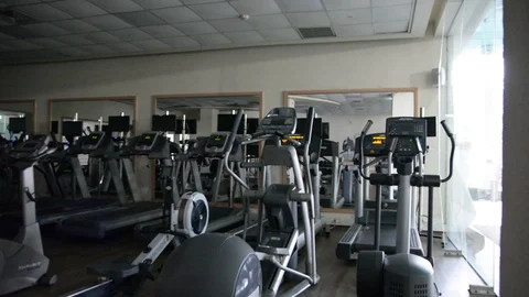 Exercise machines in the closed gym low light soft selective focus  Видео 100092686