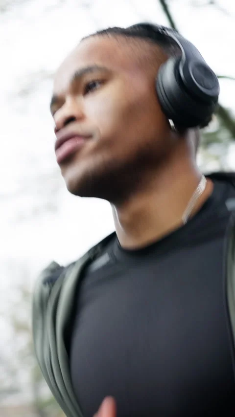 Exercise, man or running with headphones in rain for fitness dedication, pace Stock Footage 336707252