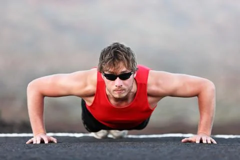 Exercise man training push ups - Fit muscular male fitness model Stock Photos