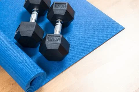 Exercise mat and dumbbells Stock Photos