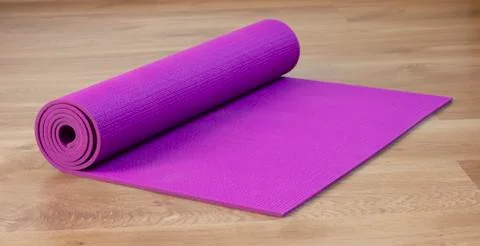Exercise mat on wood floor Stock Photos