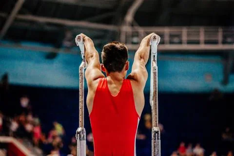 Exercise on parallel bars gymnastics Stock Photos