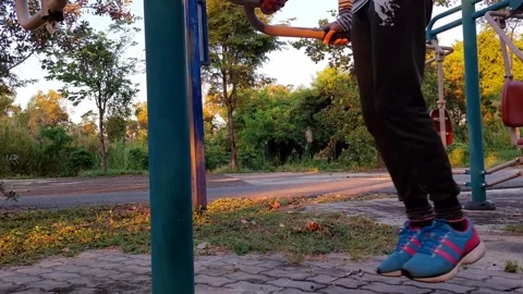 Exercise person  by swinging on double bars, swinging and cycling in the air. Stock Footage 256802177