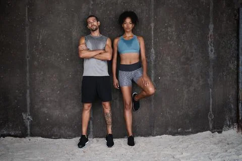 Exercise, serious and portrait of couple on wall background for workout, body Foto stock