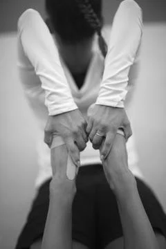 Exercise for stretching the muscles of the back with hands closed and legs in Stock Photos