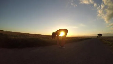Exercise at sunset. Stock Photos