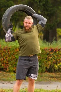 Exercise with the tire. Stock Photos