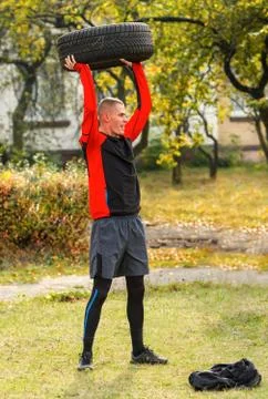 Exercise with the tire. Stock Photos