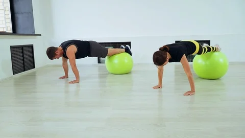 Exercise using fitball. The guy with the girl doing pilates in the gym. Stock Footage 112281756