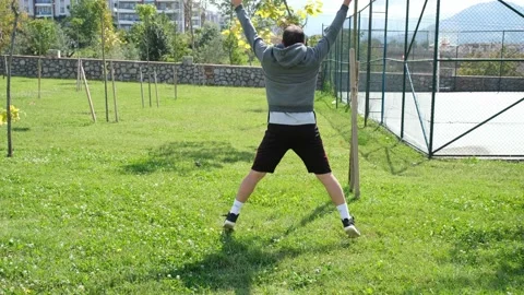 Exercise, young man exercises with legs and arms by jumping Stock Footage 164072014