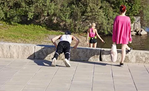 Exerciser doing push-ups on the beach promenade Stock Photos