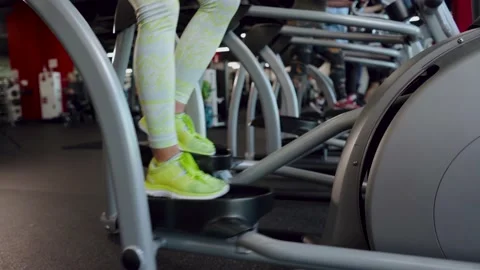 Exercises on a walking simulator. Close-up of the legs. The woman goes in for Stock Footage 143043818