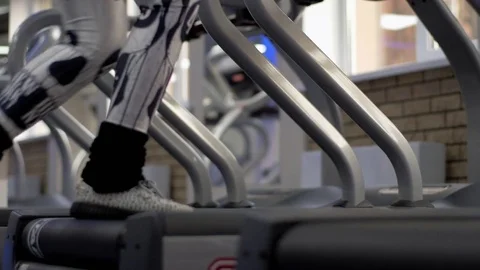 Exercising in the gym, treadmill cardio workout - detail close-up of beautiful Stock Footage 73484569