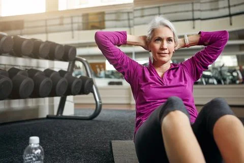 Exercising holds a lot of transformative power. a mature woman working out at Stock Photos