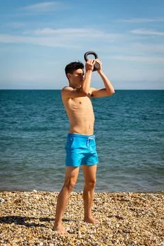 Exercising with a kettlebell weight Stock Photos