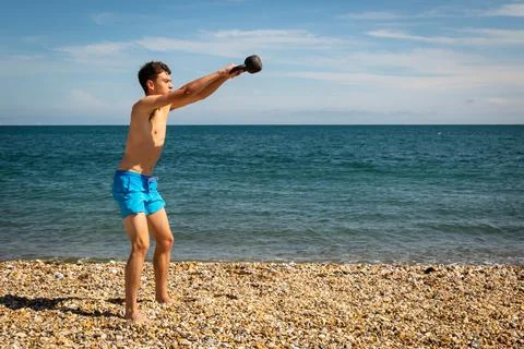 Exercising with a kettlebell weight Stock Photos