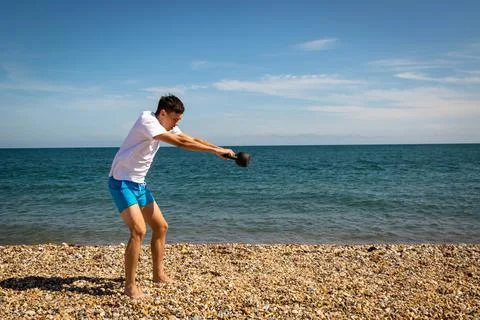Exercising with a kettlebell weight Stock Photos