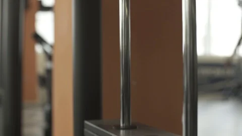 Exercising on the lat weightlifting machine Stock Footage 128585368