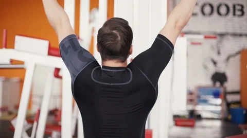 Exercising on pull down weight machine Stock Footage 62409492