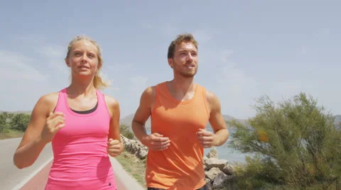 Exercising running couple jogging on beach Stock Footage 42597506