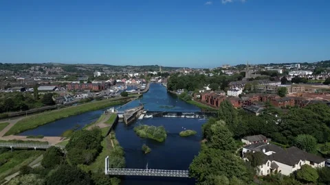 Exeter, Devon, England: DRONE VIEWS: River Exe, Trews Suspension Bridge &amp; Weir Stock Footage 265023105