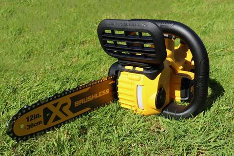 EXETER, DEVON, ENGLAND - JUNE 15TH 2021: Dewalt 18 volt cordless chainsaw on  Photos