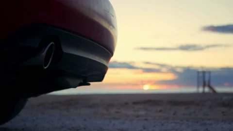 Exhaust closeup in front of the beach. Audio of idling and accelerating. Bokeh. Stock Footage 168204341