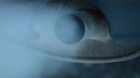 Exhaust coming out from tailpipe on a idling parked car Stock Footage 47262462