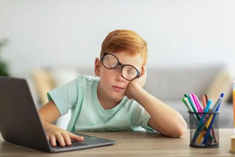 Exhausted boy fell asleep while were doing homework Stock Photos