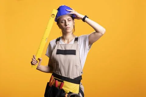 Exhausted builder looking overwhelmed by renovation project Stock Photos